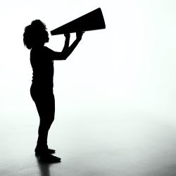 Person holding up a large megaphone