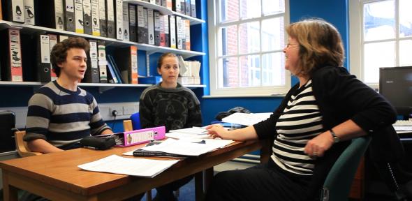 Two students participating in a supervision in a College room