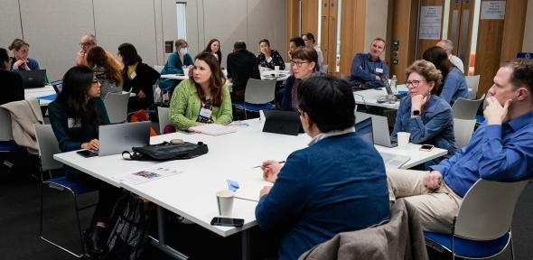 Delegates at a table having a discussion during a workshop
